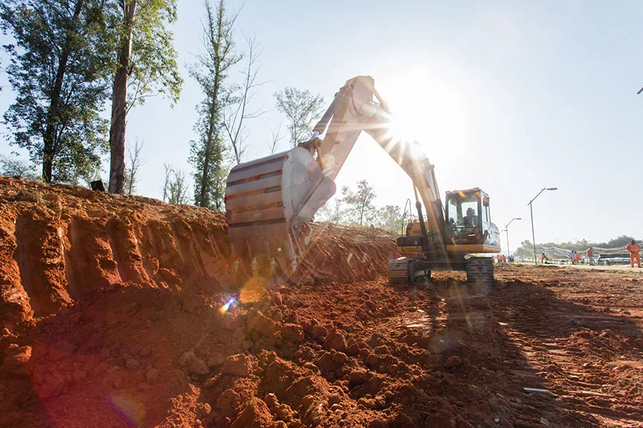 excavator clearing land at construction site orlando fl