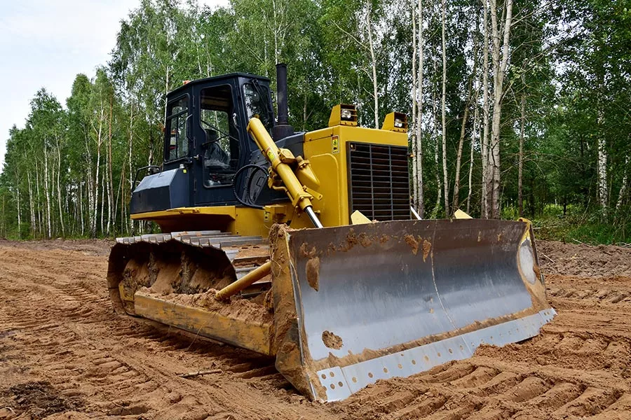 yellow excavator land clearing at residential property orlando fl